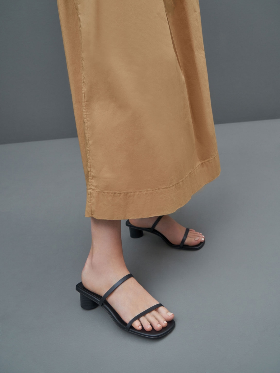 model wearing charles and keith singapore Double thin Strap Cylindrical Heel Mules in black
