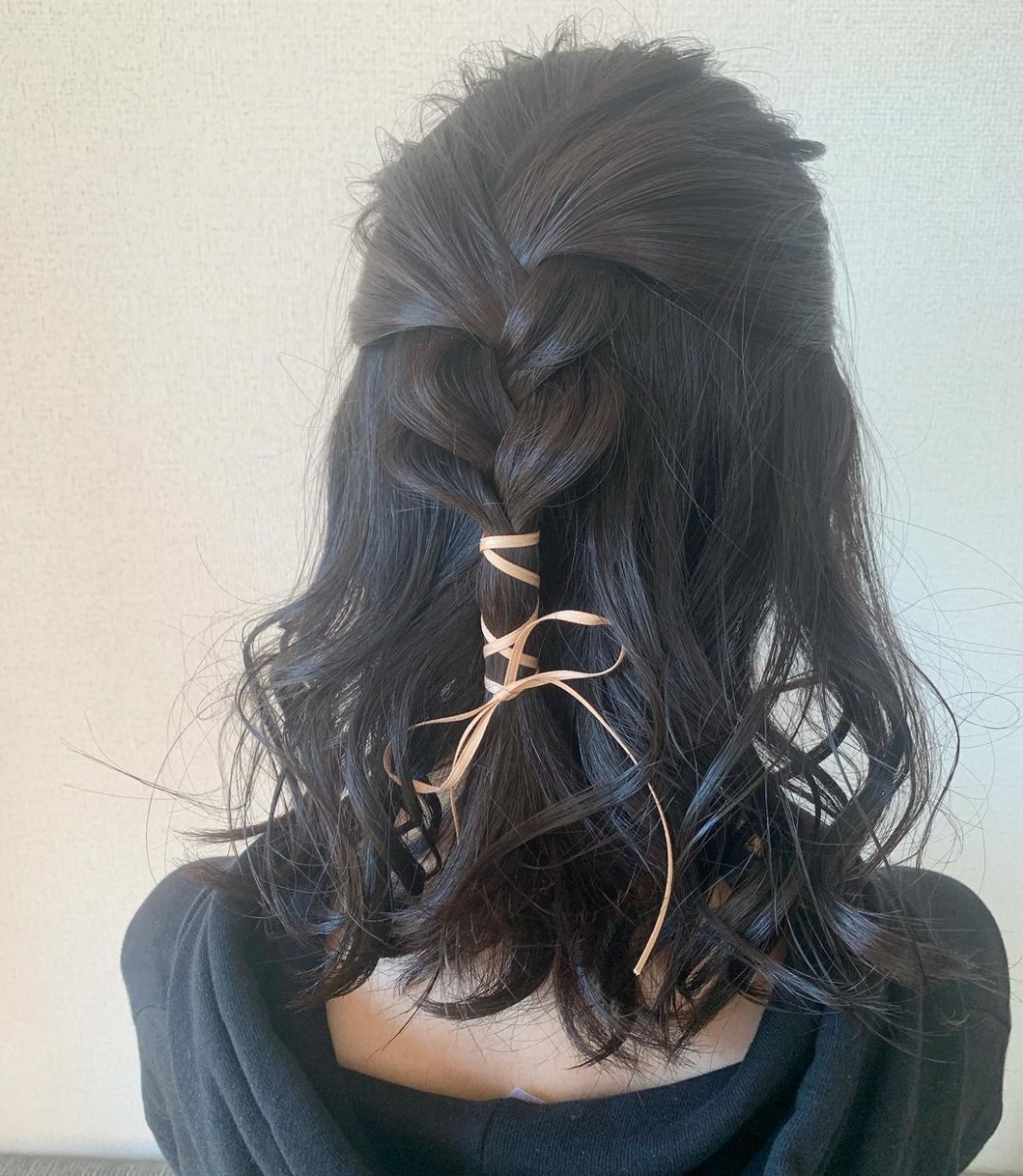 japanese half french braid hairstyle with ribbon wrapped around the hair