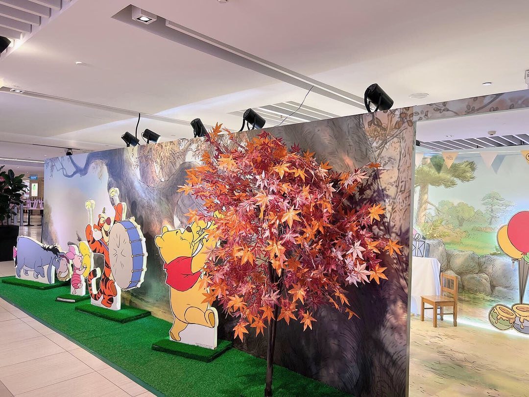 winnie the pooh goldwood pop up store photo wall and faux tree with autumn leaves at suntec city