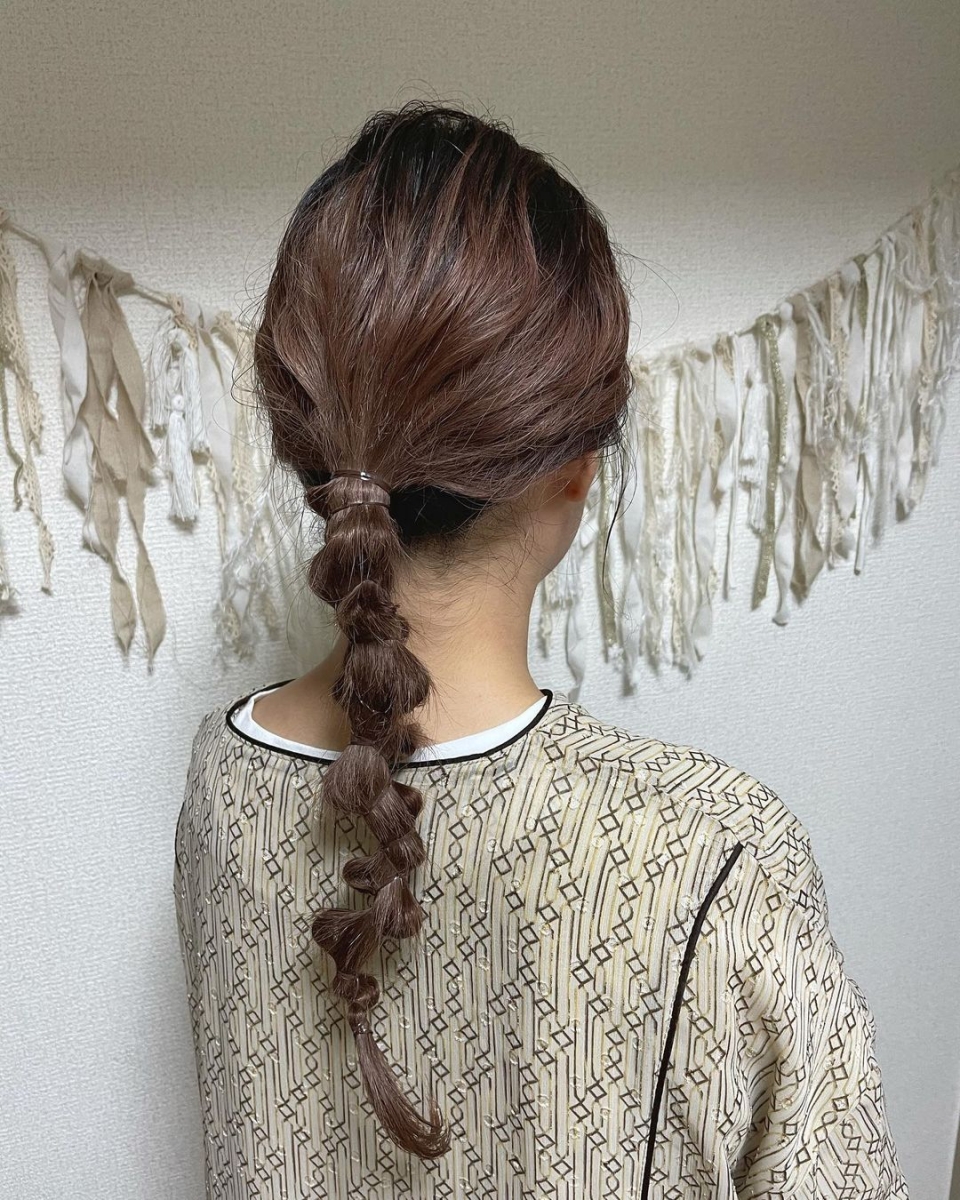 japanese hairstyle low messy ponytail with hair wrapped sections