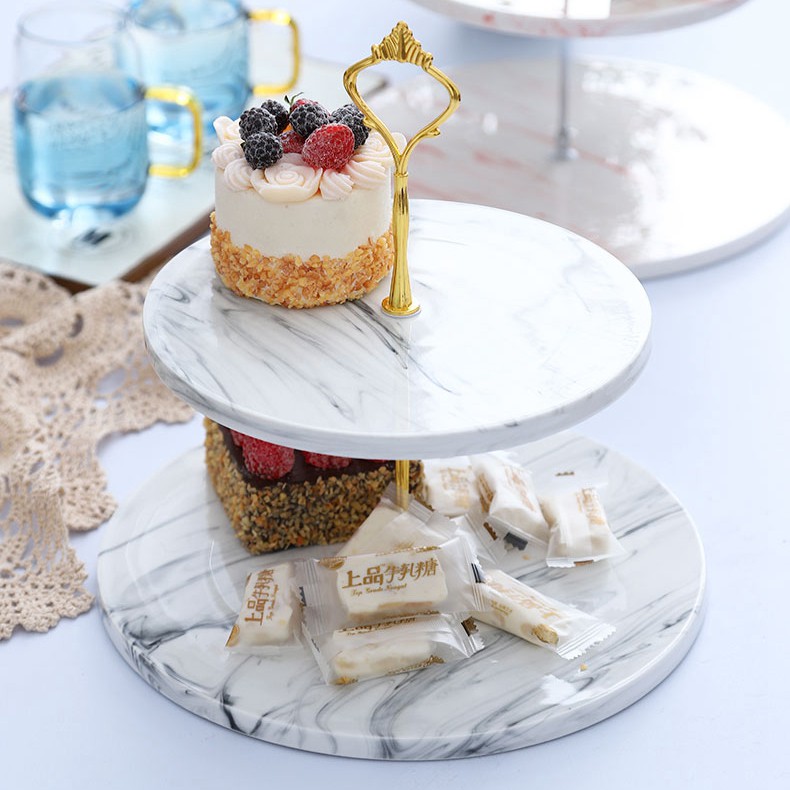 marble high tea stand gold handle with cakes and sweets