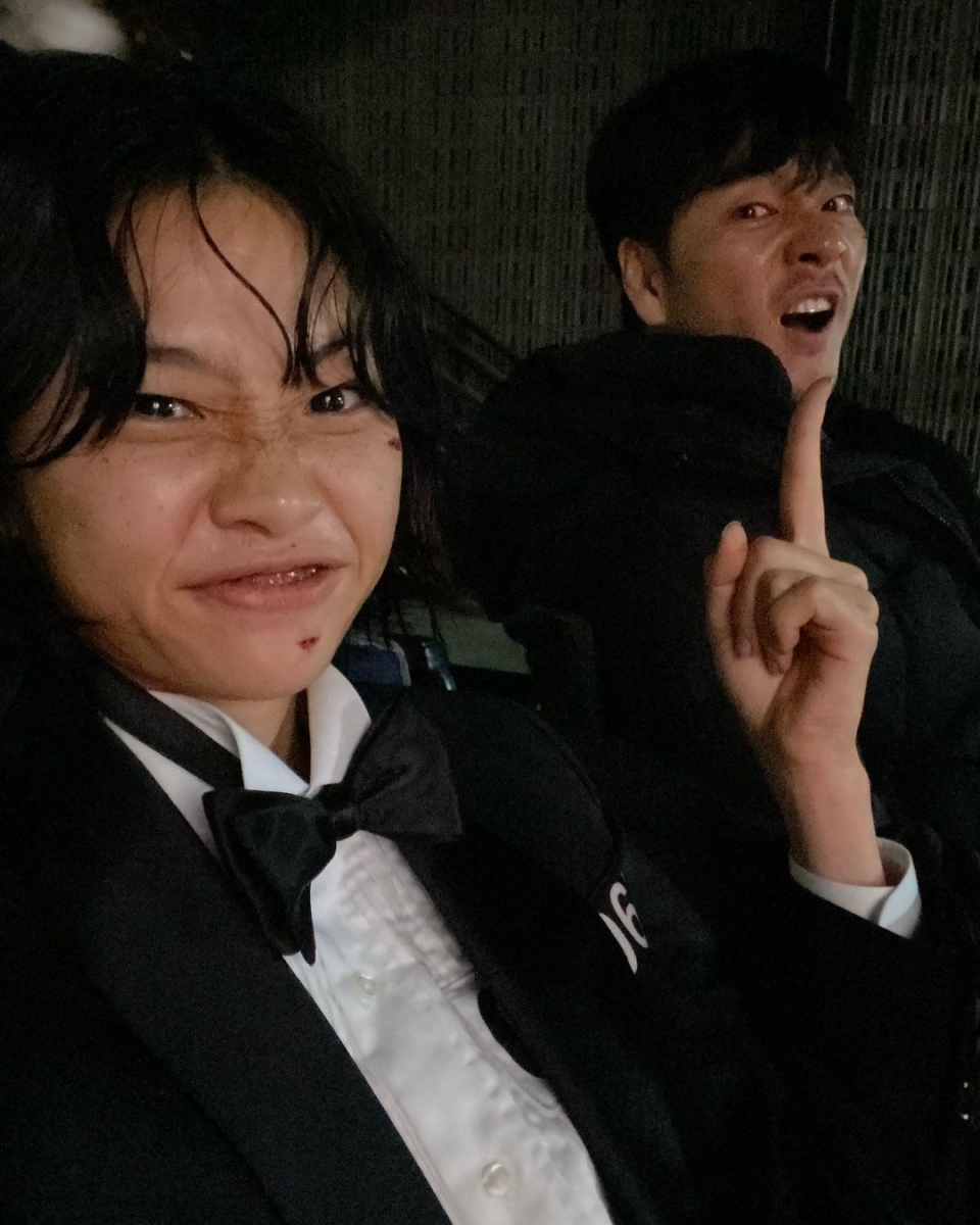squid game behind the scenes dinner park haesoo and jung hoyeon as Cho Sangwoo and kang saebyeok in suits and bowties