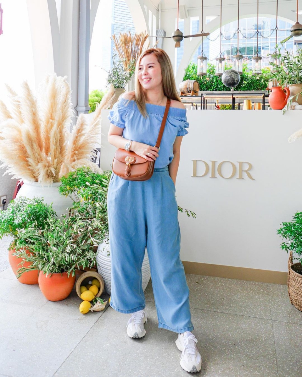 woman posing for photo at dior cafe Clifford Pier at The Fullerton Bay Hotel singapore