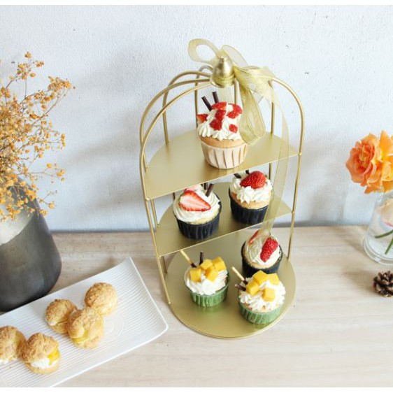 gold bird cage afternoon tea stand with pastry cakes singapore