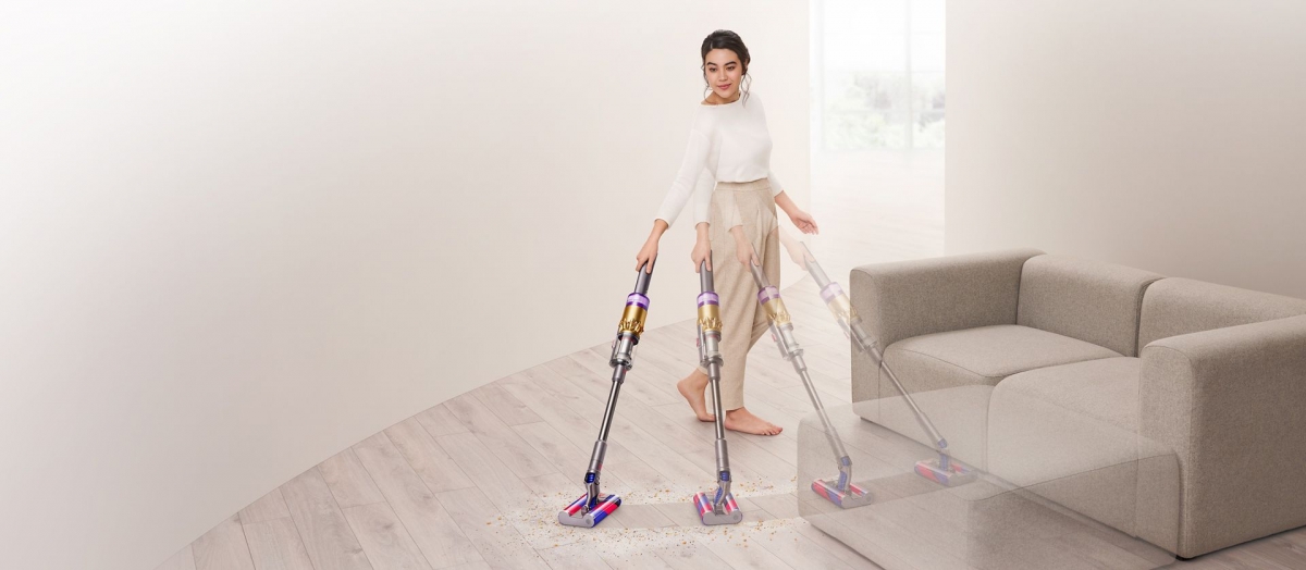 woman using the dyson omni-glide vacuum cleaner