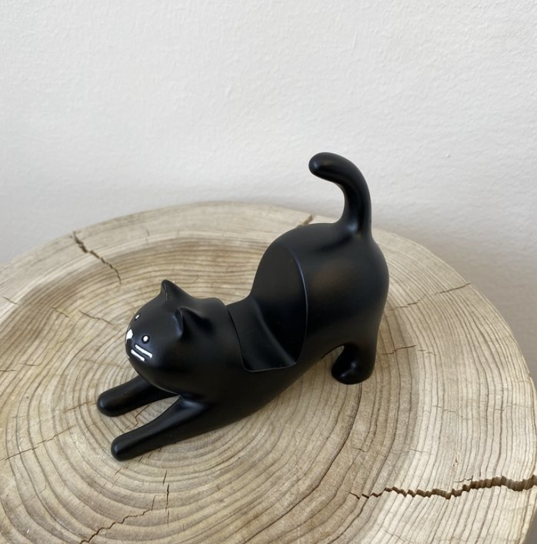Black cat stretching phone stand