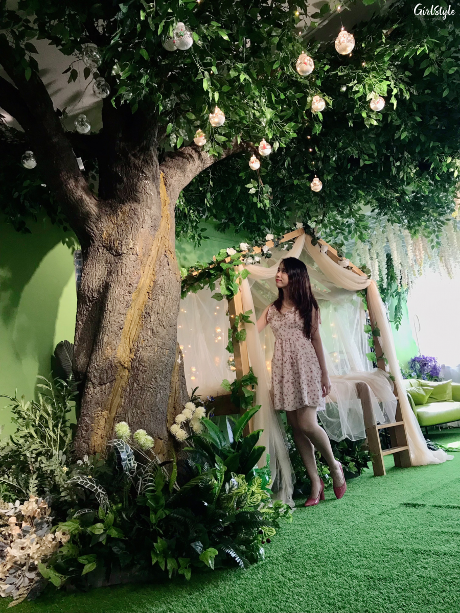 Floral garden themed zone with tree and canopy daybed at I WAN Selfie Studio