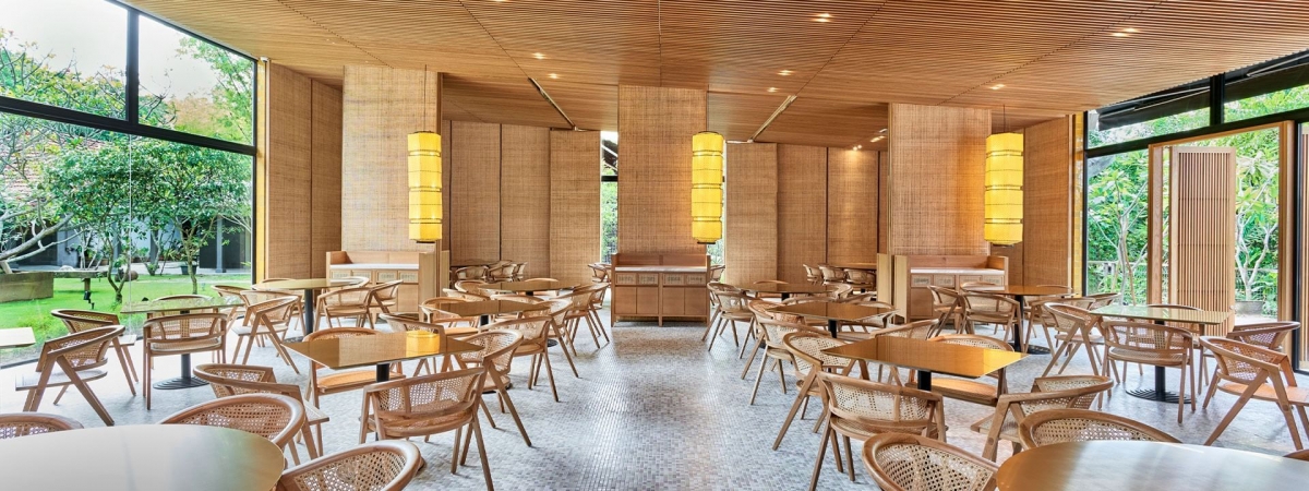 Min Jiang at Dempsey restaurant interior with view of greenery