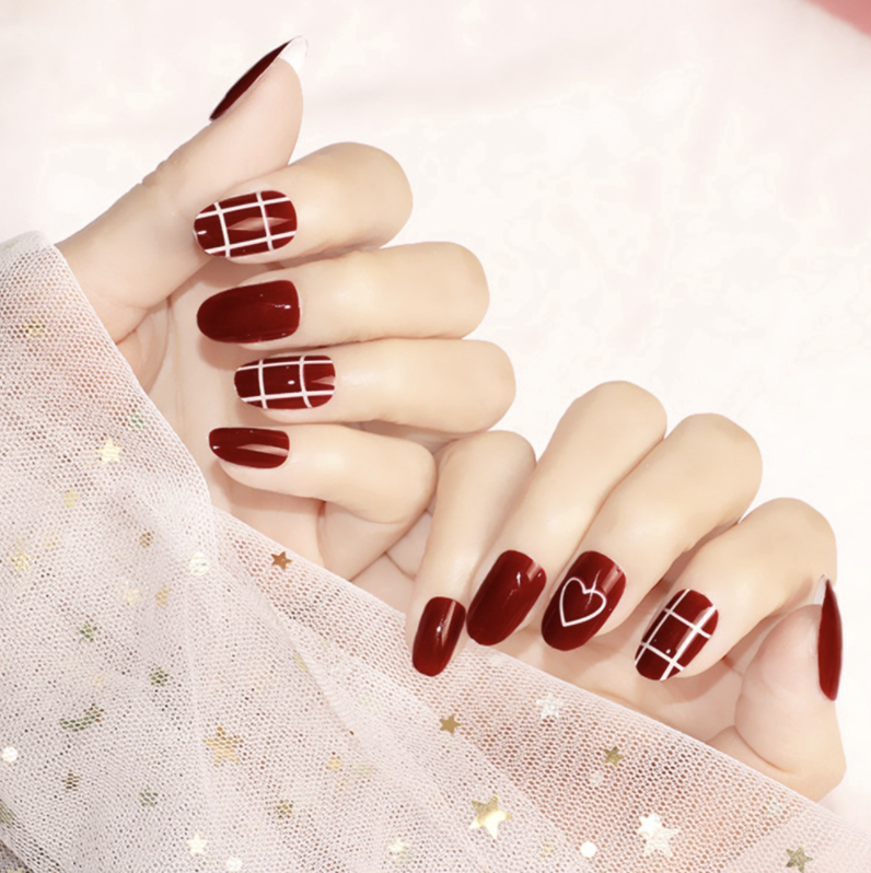 Red nails with heart and lattice design