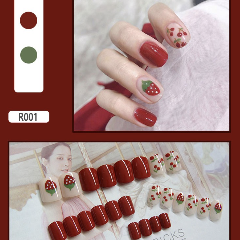 Red nails with strawberry and cherry motifs