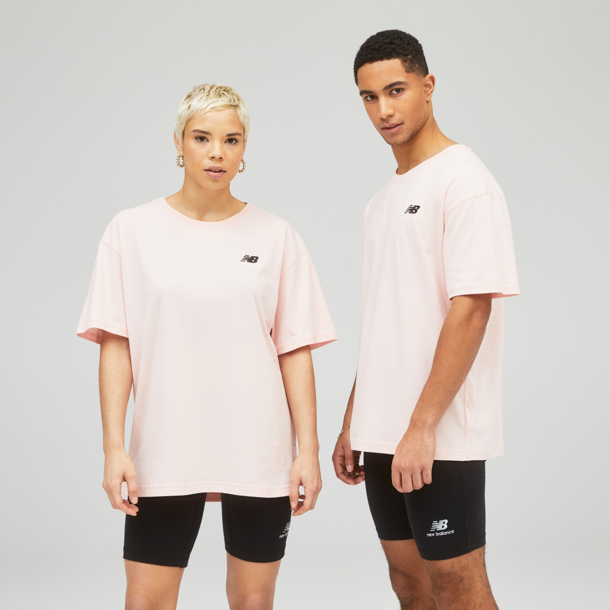 New Balance Uni-ssentials pink t-shirt and black shorts
