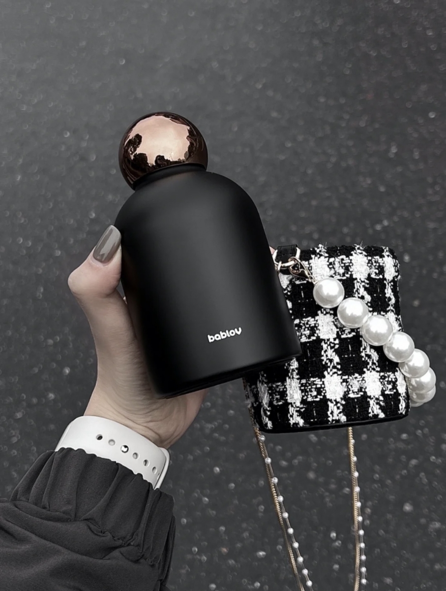 Black and gold thermos water bottle with tweed cover, chain and pearls