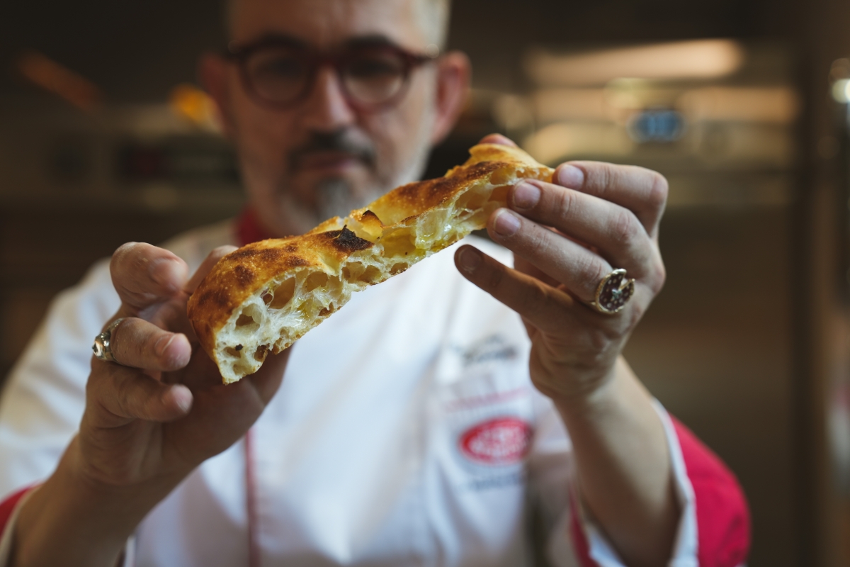 Light crispy texture of Romana-style pizza with air pockets within its pie and crust - L’Arte Pizza & Focaccia