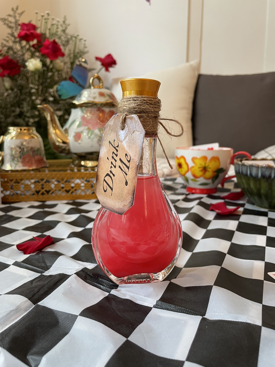 Alcoholic beverage in a 'Drink Me' potion bottle - Have I Gone Mad pop-up at The Secret Patio
