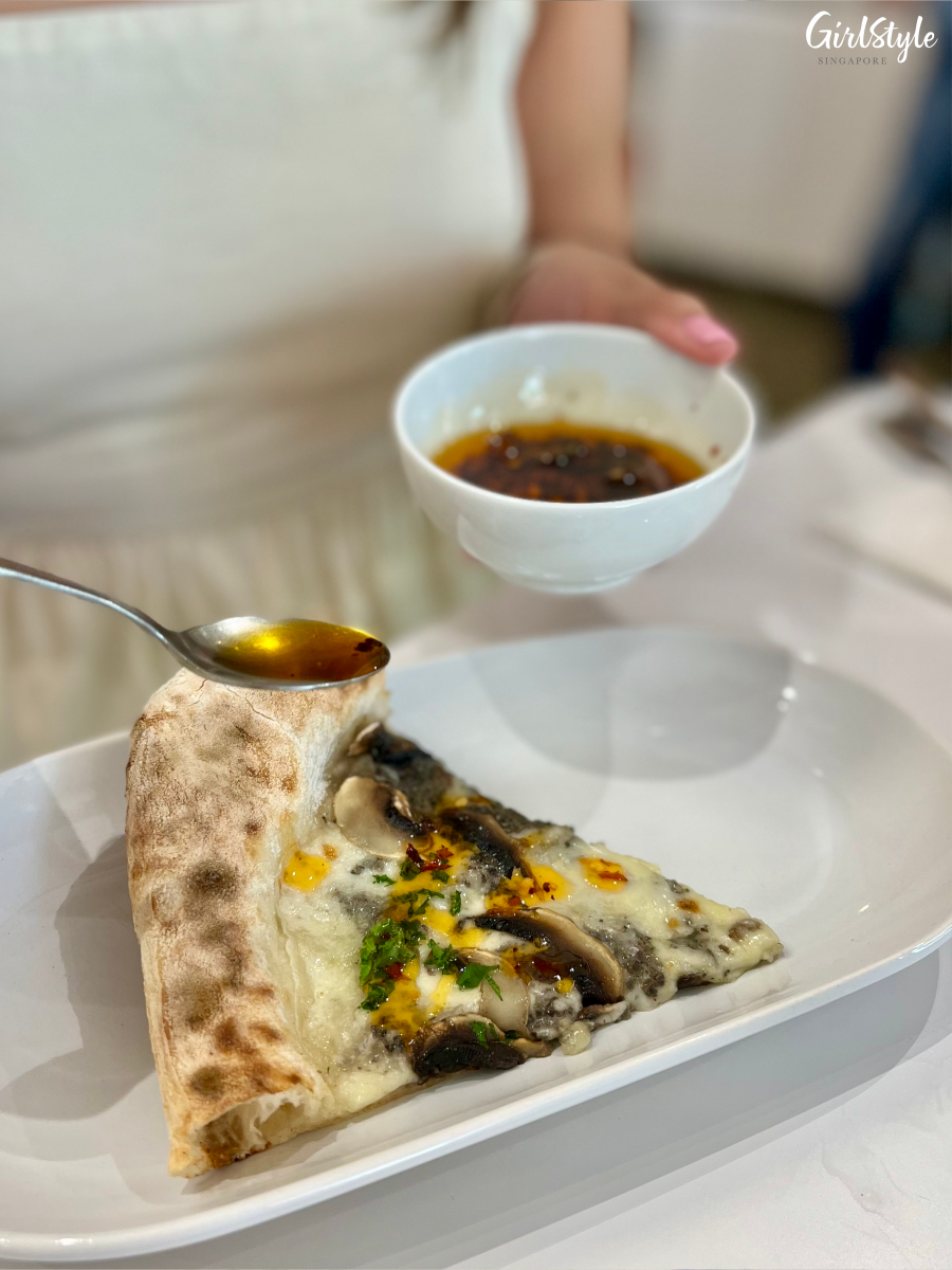 Pizza drizzled with housemade chilli oil