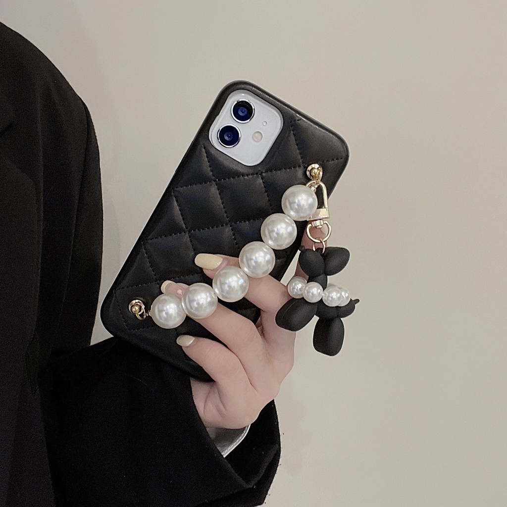 Black quilted iPhone case with faux pearl bracelet and poodle charm