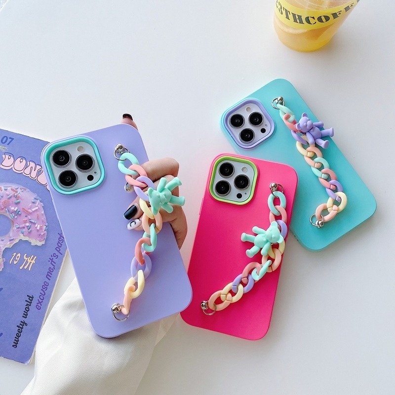 Candy-coloured iPhone case with chain bracelet and bear charm