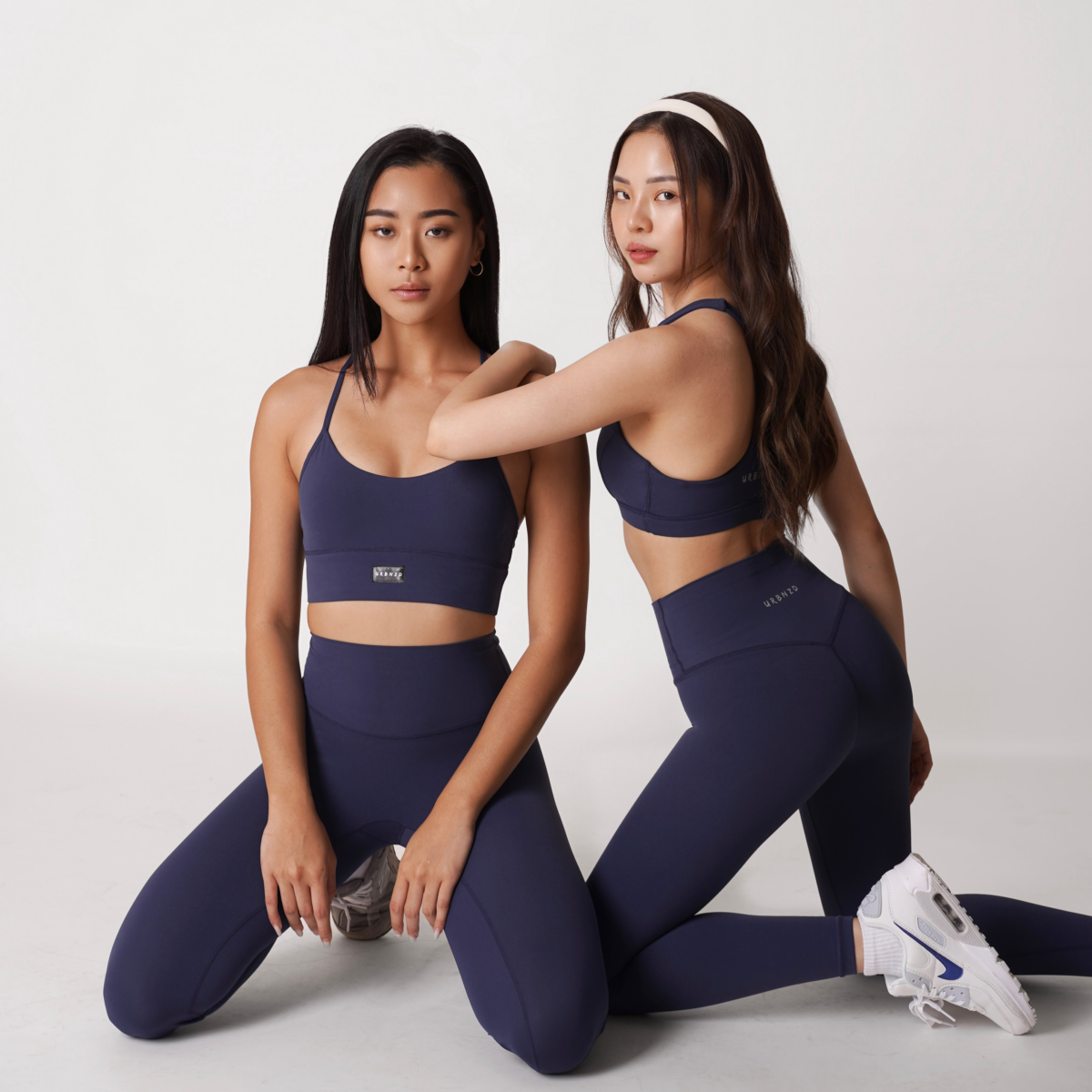 Revitalise Scoop Neck Bra & Revitalise Highrise Leggings in Midnight (left); Rylie Racerback Bra & Revitalise Highrise Leggings in Midnight (right)