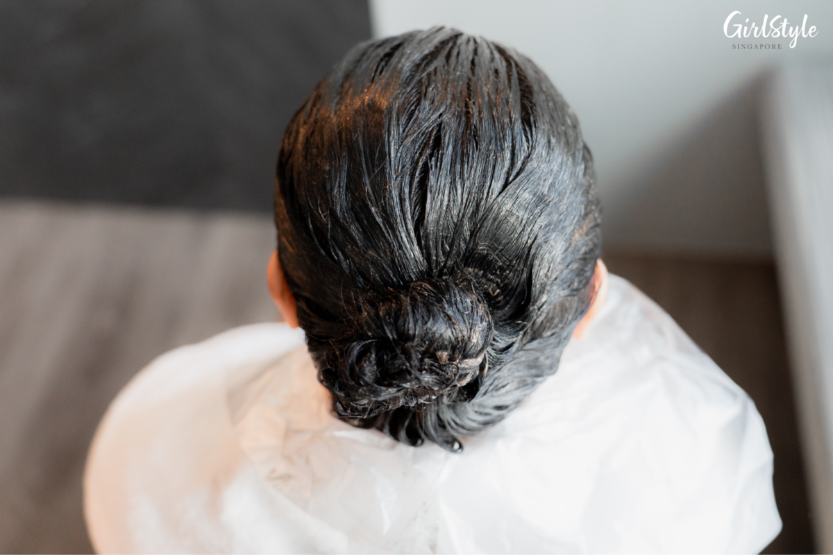 Letting her hair soak up the dye for 15 minutes