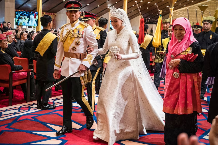 Prince Abdul Mateen and Yang Mulia Anisha Rosnah walk down the aisle during their wedding reception at Istana Nurul Iman on 14 January 2024