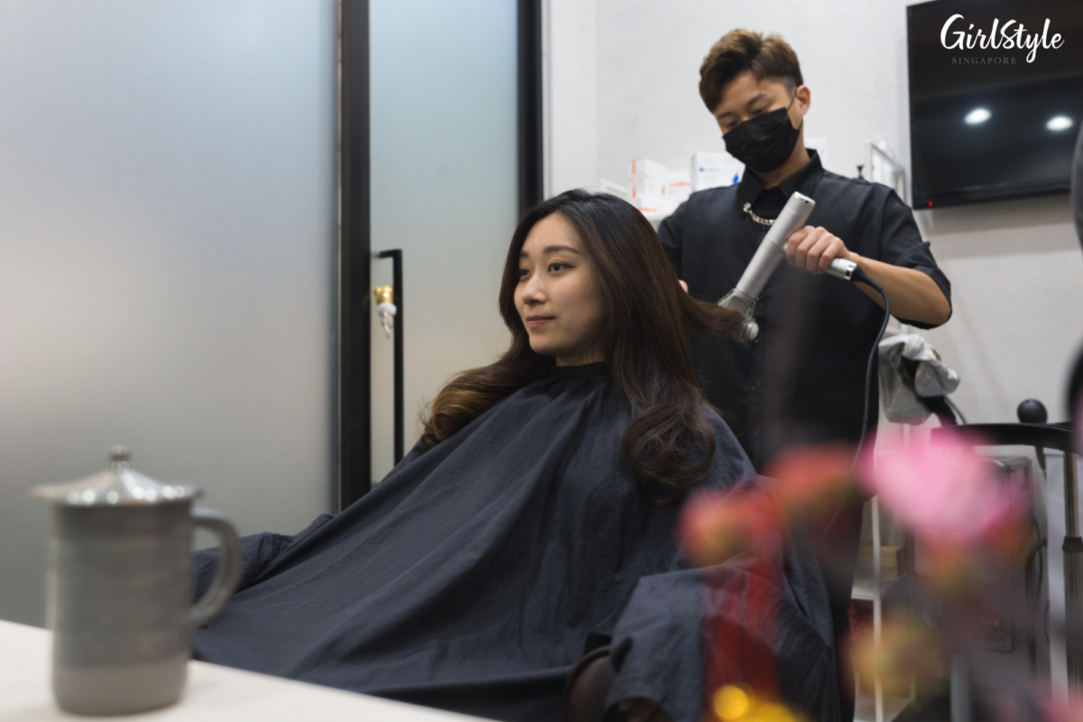 The stylist dries and styles Kristy’s hair