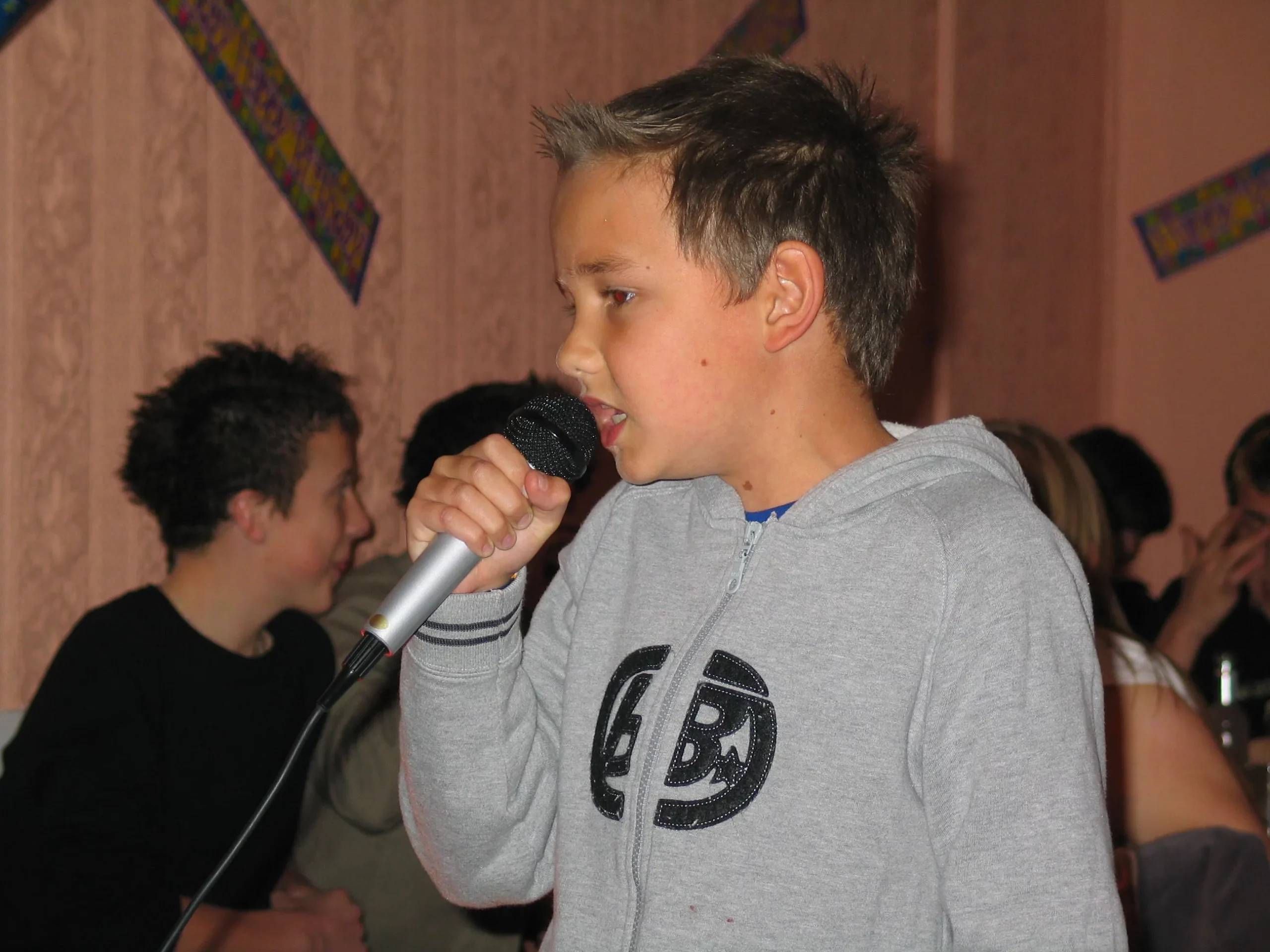 A young Liam Payne singing