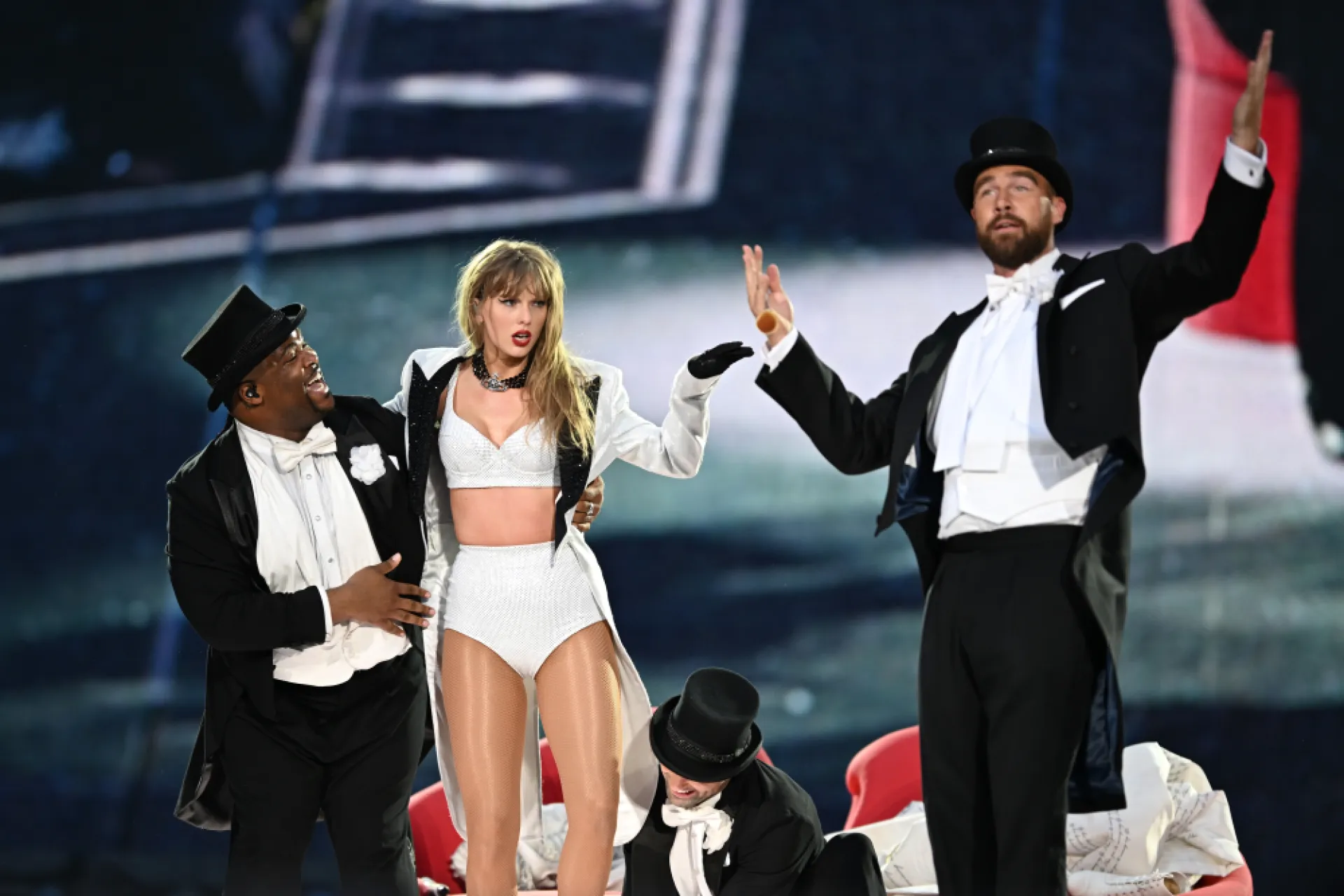 Taylor Swift with Kameron Saunders and Travis Kelce onstage at the Eras Tour on 3 June 2024 in London