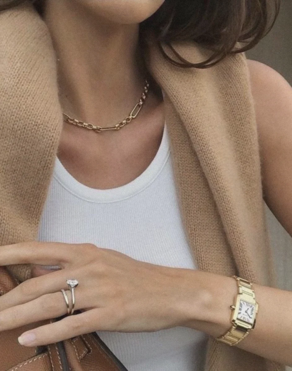 Keep accessories subtle with pearls, dainty gold, classic watches, and leather bags