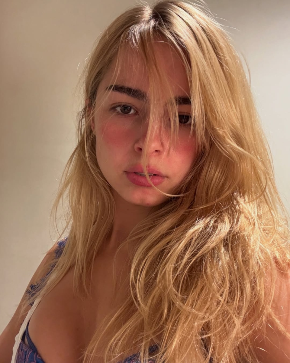 Addison Rae with rosy cheeks, tinted lips, and no mascara